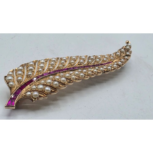 25 - An unmarked yellow metal pearl and ruby Fern Brooch set with graduated line of channel set rubies an... 