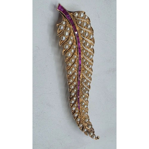 25 - An unmarked yellow metal pearl and ruby Fern Brooch set with graduated line of channel set rubies an... 
