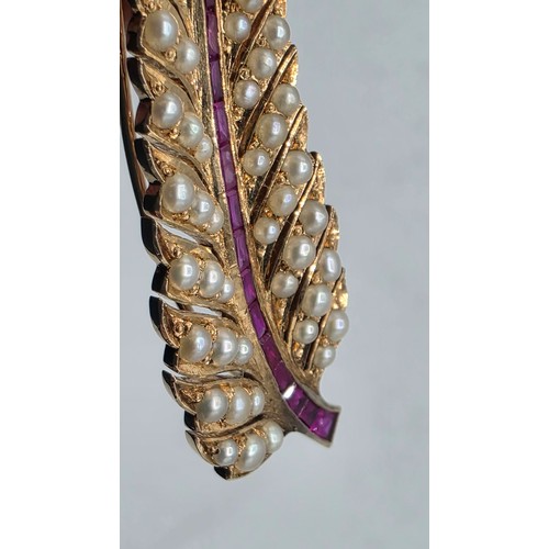 25 - An unmarked yellow metal pearl and ruby Fern Brooch set with graduated line of channel set rubies an... 