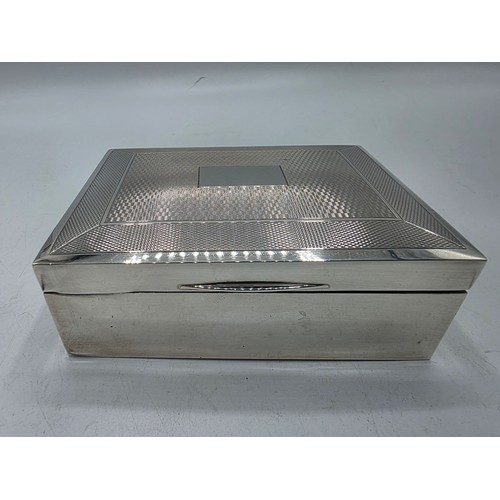 21 - A sterling silver cedar lined cigarette box with engine turned decoration.  Harman Brothers Birmingh... 