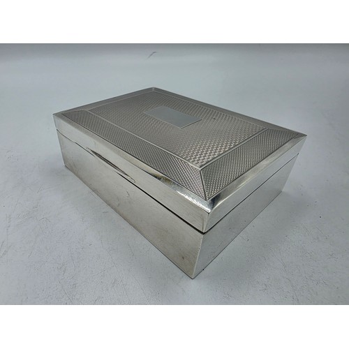 21 - A sterling silver cedar lined cigarette box with engine turned decoration.  Harman Brothers Birmingh... 