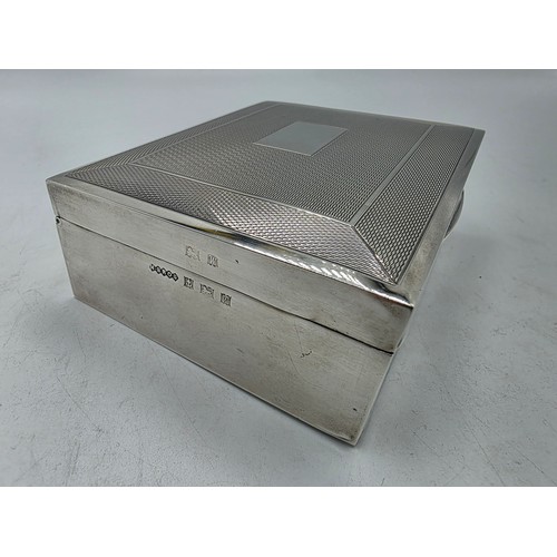 21 - A sterling silver cedar lined cigarette box with engine turned decoration.  Harman Brothers Birmingh... 