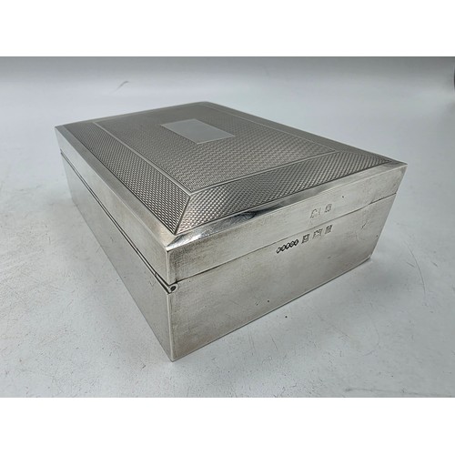 21 - A sterling silver cedar lined cigarette box with engine turned decoration.  Harman Brothers Birmingh... 