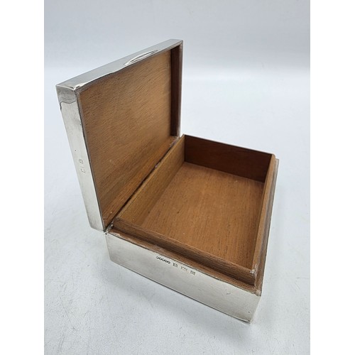 21 - A sterling silver cedar lined cigarette box with engine turned decoration.  Harman Brothers Birmingh... 