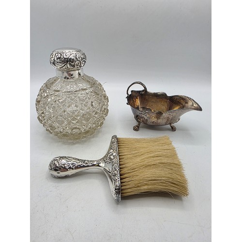 22 - A collection of sterling silver items to include small sauceboat, silver topped glass scent bottle &... 