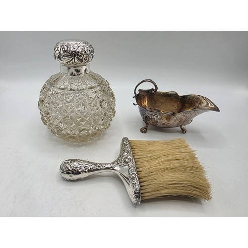 22 - A collection of sterling silver items to include small sauceboat, silver topped glass scent bottle &... 