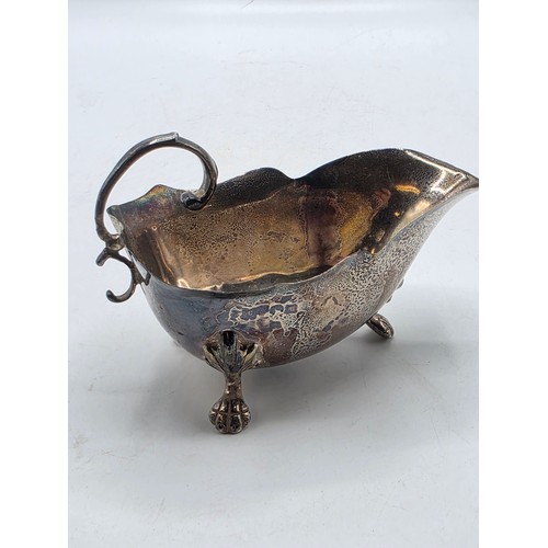 22 - A collection of sterling silver items to include small sauceboat, silver topped glass scent bottle &... 