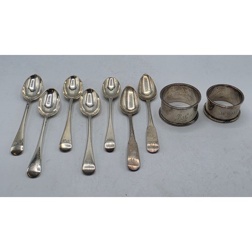 33 - A collection of sterling silver tea spoons with two sterling napkin rings 178 g