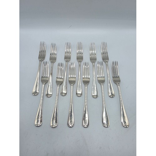 30 - A set of twelve sterling silver dining forks by Goldsmith and Silversmith Company London 1905.  775 ... 