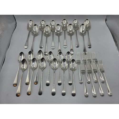28 - A collection of sterling silver flatware, to include 8 desert forks, 12 desert spoons, 11 serving sp... 
