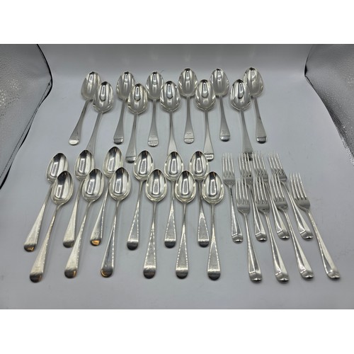 28 - A collection of sterling silver flatware, to include 8 desert forks, 12 desert spoons, 11 serving sp... 