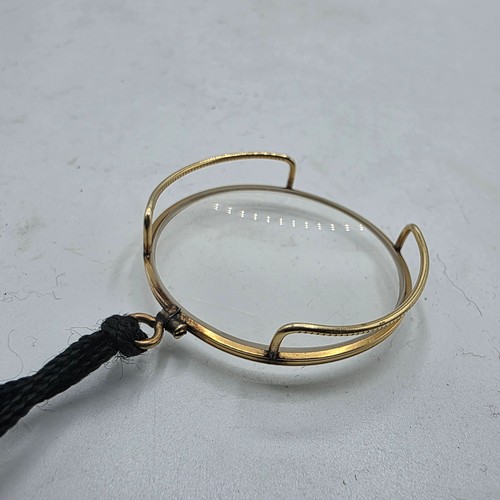 36 - An unmarked yellow metal monocle