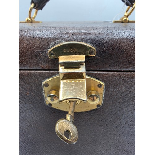 23 - A vintage Gucci leather jewellery travel case with green felt lined interior 34 cm x 19 cm x 20 cm H