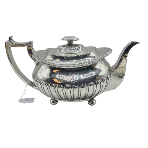 43 - A Scottish sterling silver three piece tea set with half fluted design on ball feet. By James McKay,... 