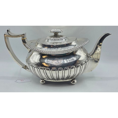 43 - A Scottish sterling silver three piece tea set with half fluted design on ball feet. By James McKay,... 