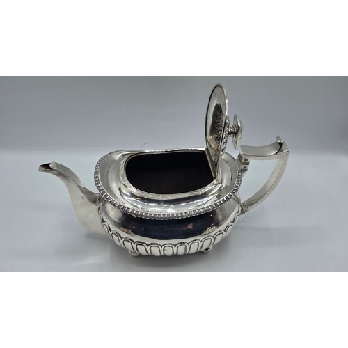 43 - A Scottish sterling silver three piece tea set with half fluted design on ball feet. By James McKay,... 