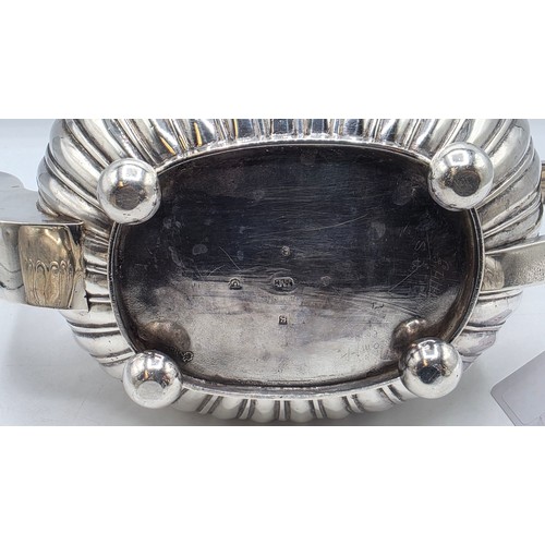 43 - A Scottish sterling silver three piece tea set with half fluted design on ball feet. By James McKay,... 