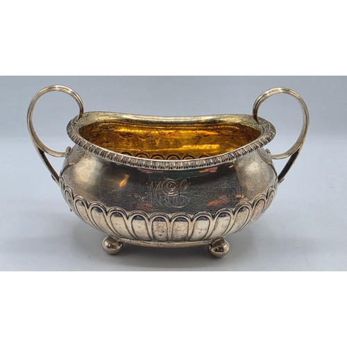 43 - A Scottish sterling silver three piece tea set with half fluted design on ball feet. By James McKay,... 