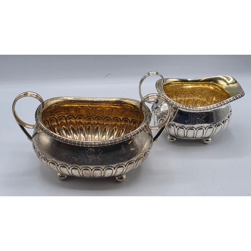 43 - A Scottish sterling silver three piece tea set with half fluted design on ball feet. By James McKay,... 