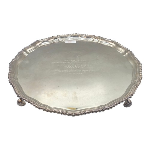 38 - A large sterling silver tray with cast rim and on four scroll feet. 36cm(d). By CJ Vander Ltd Sheffi... 