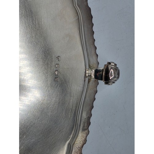 38 - A large sterling silver tray with cast rim and on four scroll feet. 36cm(d). By CJ Vander Ltd Sheffi... 