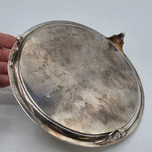 54 - A pair of sterling silver circular card trays or salvers with beaded rims on three shell feet.   Joh... 
