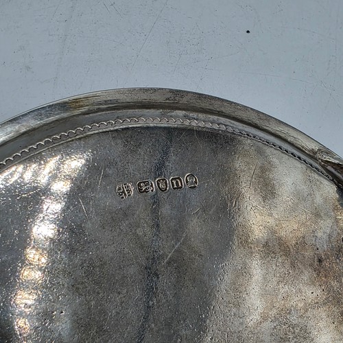 54 - A pair of sterling silver circular card trays or salvers with beaded rims on three shell feet.   Joh... 