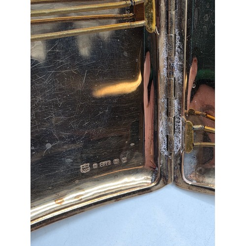 39 - A 9ct gold hip shaped cigarette case with engine turned decoration. By William Neale Birmingham 1899... 