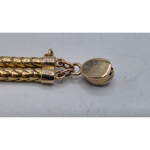 53 - An unmarked yellow metal and amethyst double snake link bracelet set with four free cut oval amethys... 