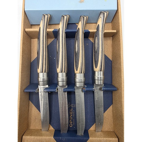 35 - A silver plated table candelabra on square cantered stepped base together with a set of steak knives