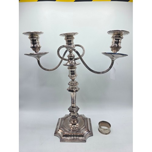 35 - A silver plated table candelabra on square cantered stepped base together with a set of steak knives