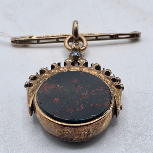 252 - Unmarked yellow metal swivel watch fob with bloodstone panel on 9 ct gold pin brooch, 6.6 g
