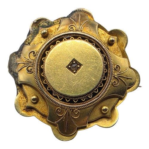251 - A yellow metal Etruscan style wheel brooch with central rose cut diamond 6 g