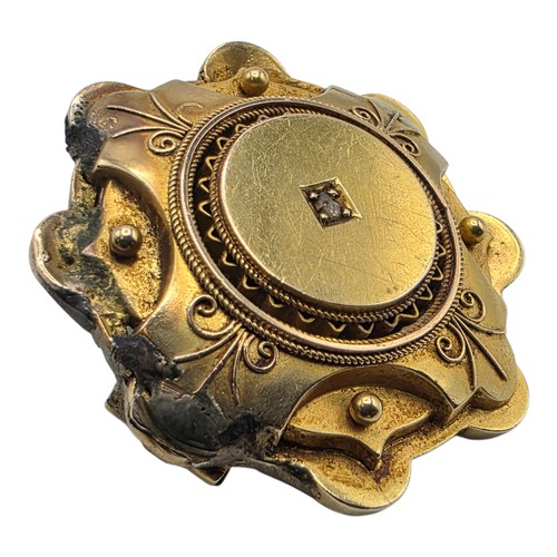 251 - A yellow metal Etruscan style wheel brooch with central rose cut diamond 6 g