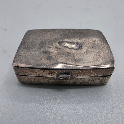 72 - A collection of sterling silver items to include decanter label, pill box, mounted rattle etc
