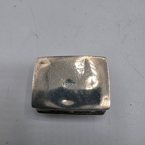 72 - A collection of sterling silver items to include decanter label, pill box, mounted rattle etc
