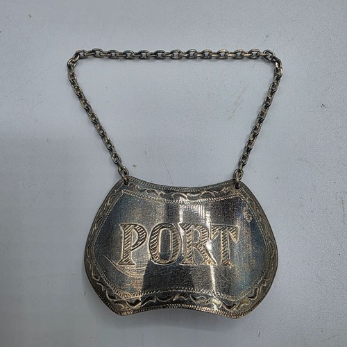 72 - A collection of sterling silver items to include decanter label, pill box, mounted rattle etc