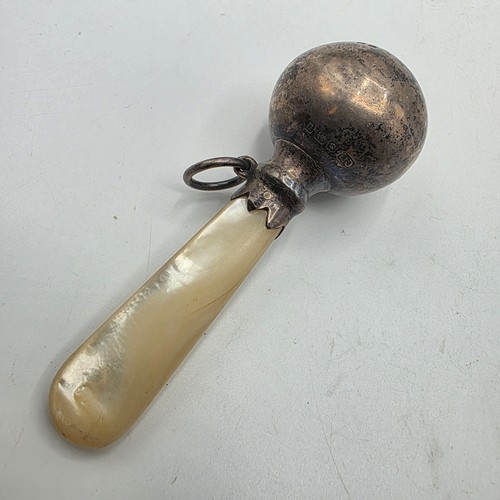 72 - A collection of sterling silver items to include decanter label, pill box, mounted rattle etc