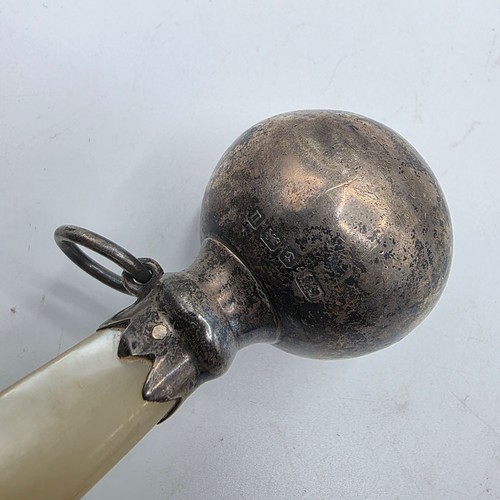 72 - A collection of sterling silver items to include decanter label, pill box, mounted rattle etc