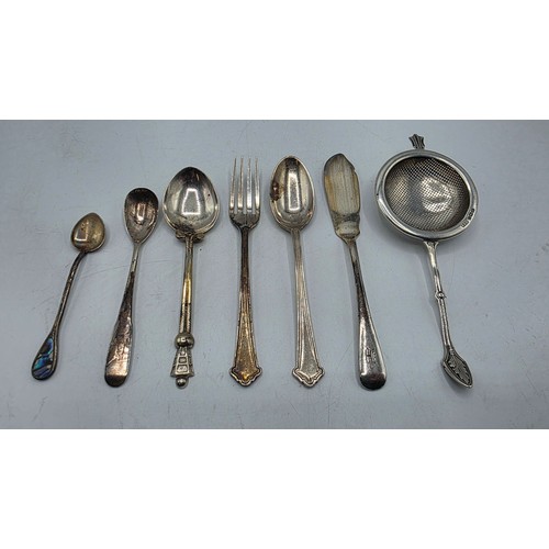 69 - A sterling silver tea strainer together with sterling silver and white metal cutlery items, various ... 