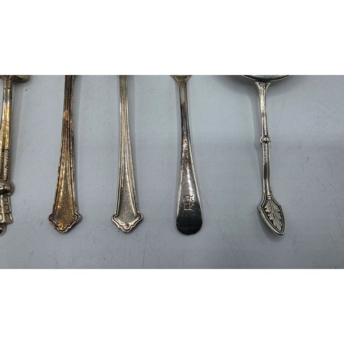 69 - A sterling silver tea strainer together with sterling silver and white metal cutlery items, various ... 
