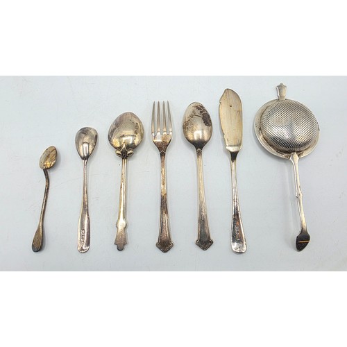 69 - A sterling silver tea strainer together with sterling silver and white metal cutlery items, various ... 