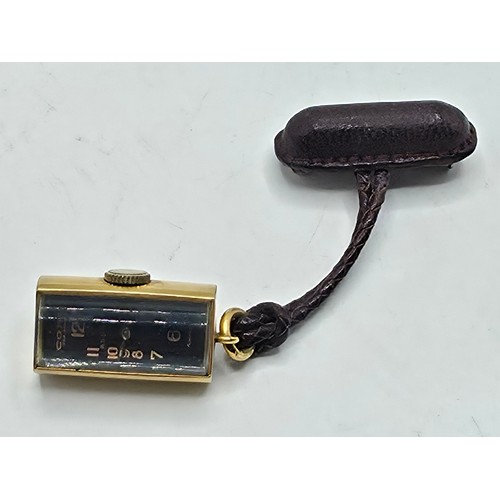 76 - A yellow metal pendant watch by Cord with black rectangular face with Arabic markers marked Asprey, ... 
