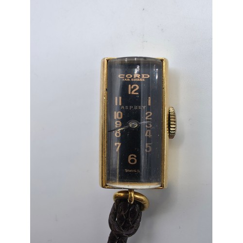 76 - A yellow metal pendant watch by Cord with black rectangular face with Arabic markers marked Asprey, ... 