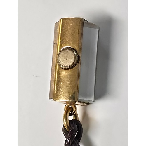 76 - A yellow metal pendant watch by Cord with black rectangular face with Arabic markers marked Asprey, ... 