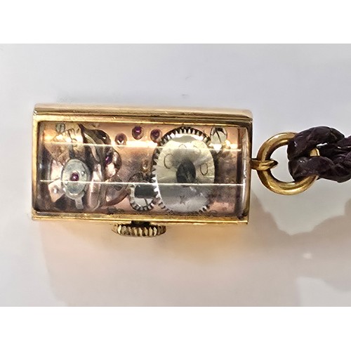 76 - A yellow metal pendant watch by Cord with black rectangular face with Arabic markers marked Asprey, ... 