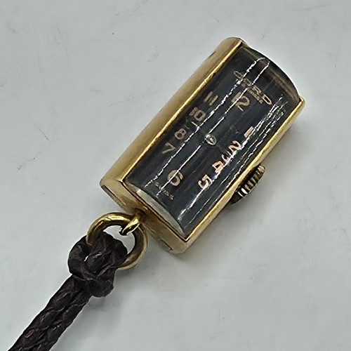 76 - A yellow metal pendant watch by Cord with black rectangular face with Arabic markers marked Asprey, ... 