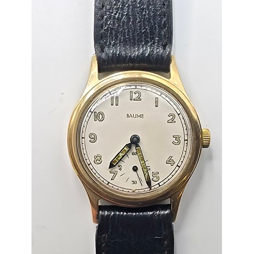 28 - A 9ct gold cased Baume Gents wristwatch. 25mm champagne face with Arabic markers and subsidiary seco... 