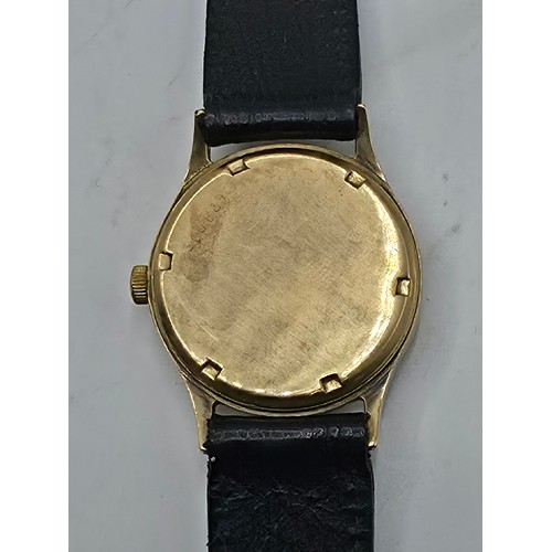 28 - A 9ct gold cased Baume Gents wristwatch. 25mm champagne face with Arabic markers and subsidiary seco... 