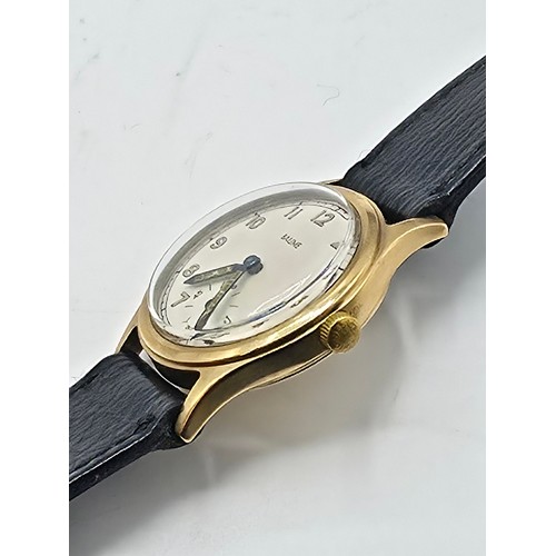 28 - A 9ct gold cased Baume Gents wristwatch. 25mm champagne face with Arabic markers and subsidiary seco... 